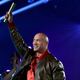 Dwayne "The Rock" Johnson holds his 2021 People's Choice Award up in the air.